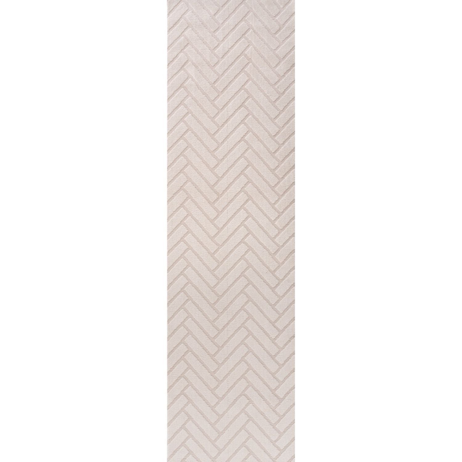 Rectangular area rug with a beige and white chevron pattern on a plain background