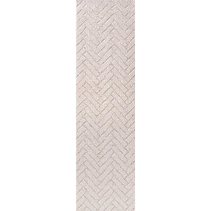 Rectangular area rug with a beige and white chevron pattern on a plain background