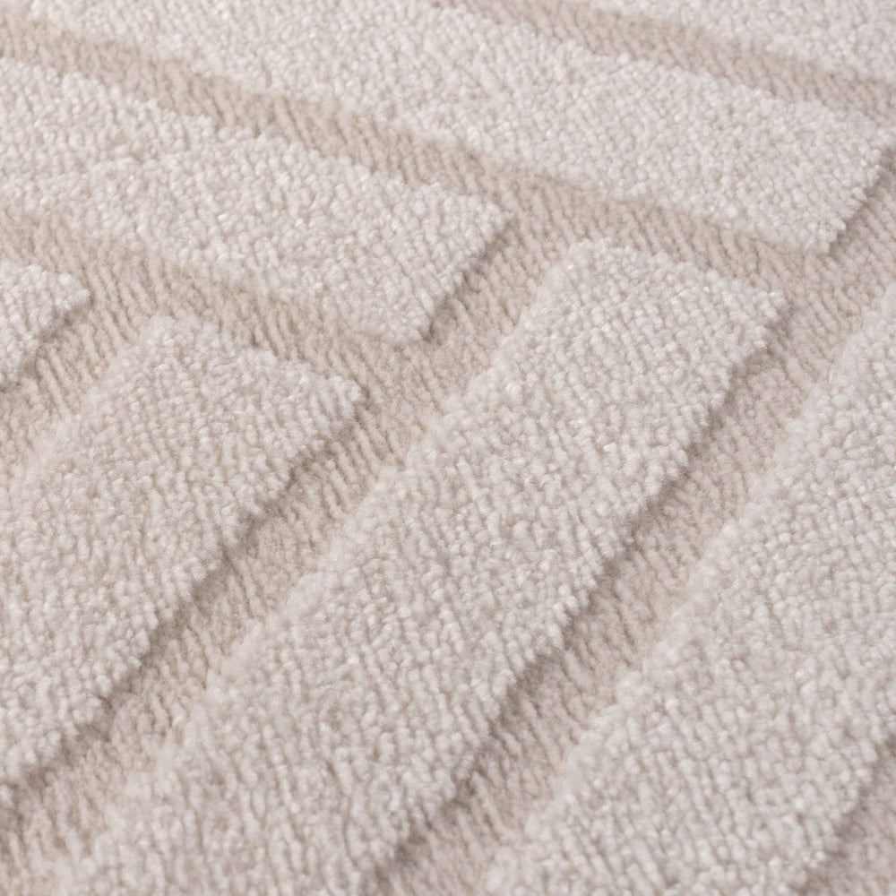 Close-up of textured beige carpet with wavy pattern