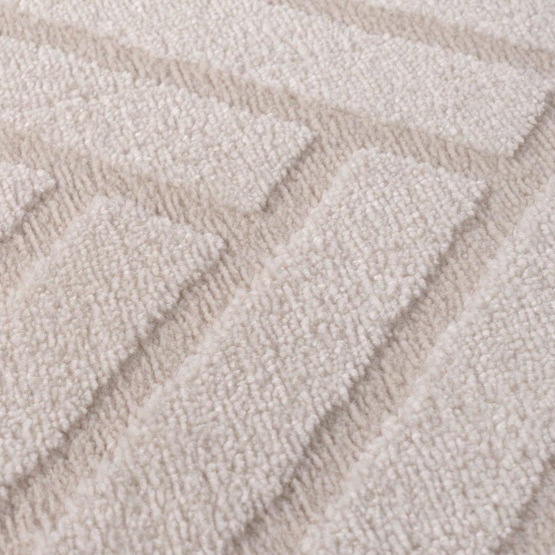 Close-up of textured beige carpet with wavy pattern
