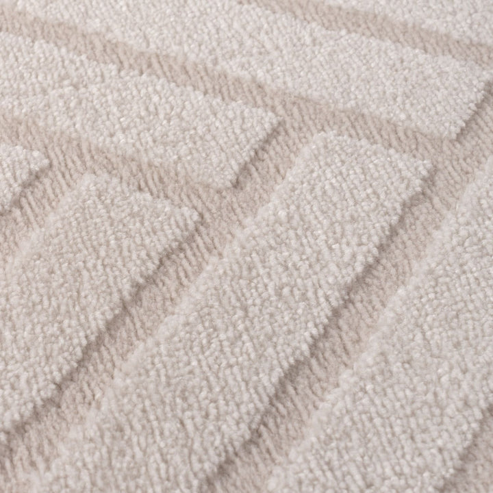 Close-up of textured beige carpet with wavy pattern