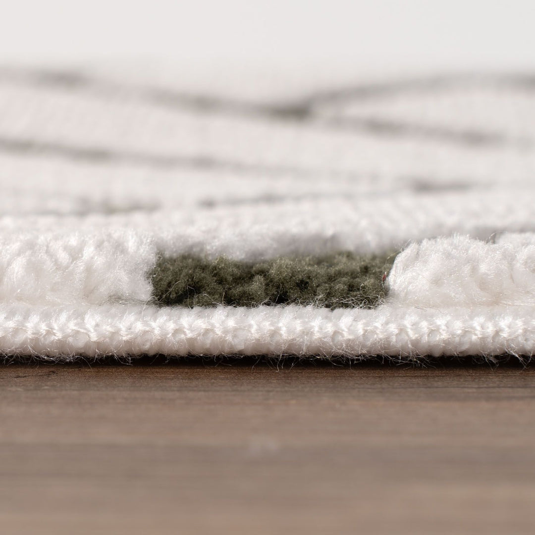 Close-up of a textured white rug on a wooden floor