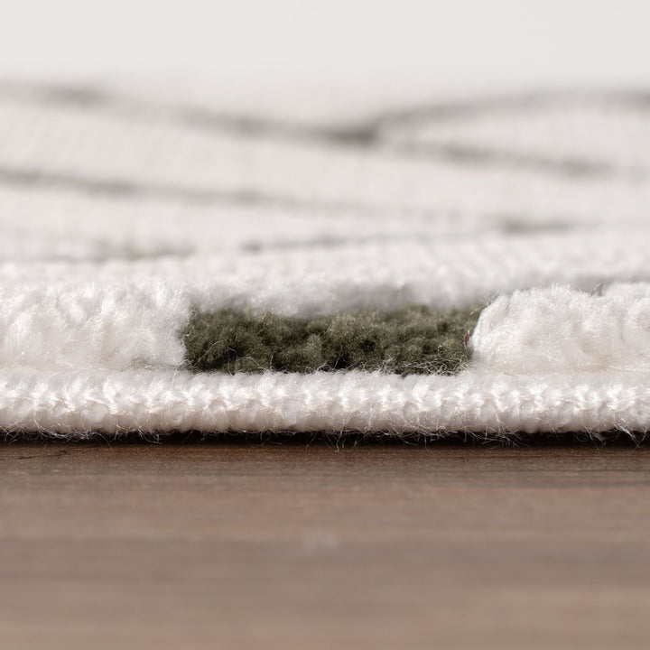 Close-up of a textured white rug on a wooden floor