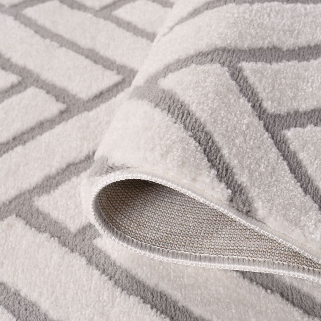 Gray textured rug with a patterned border