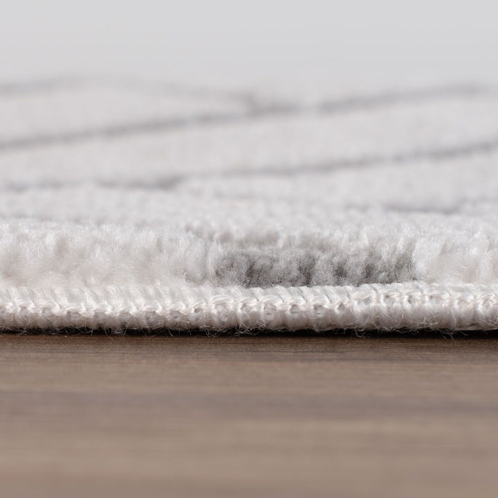 Close-up of a textured gray rug on a wooden floor