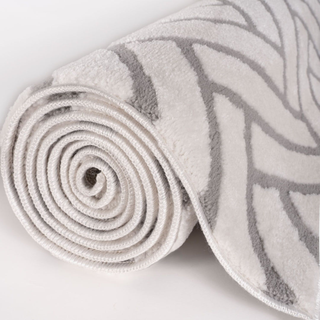 Rolled-up rug with a pattern on a light background