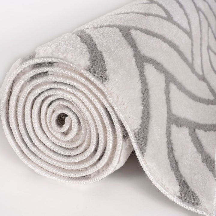 Rolled-up rug with a pattern on a light background