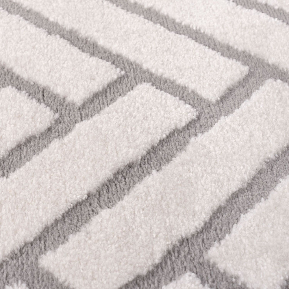 Close-up of a textured gray and white patterned rug