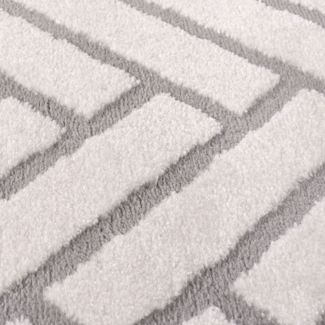 Close-up of a textured gray and white patterned rug