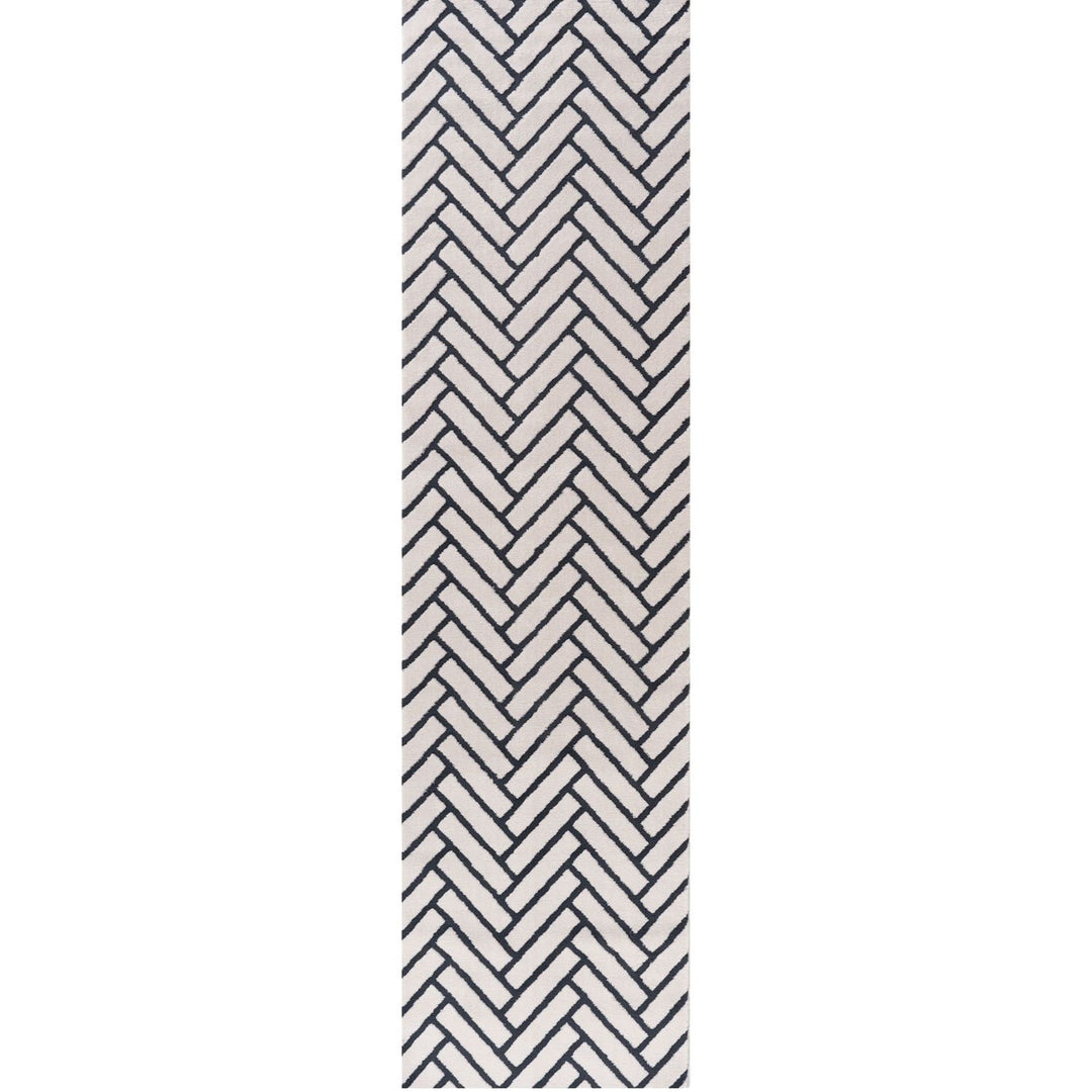 Black and white chevron patterned rug on a white background