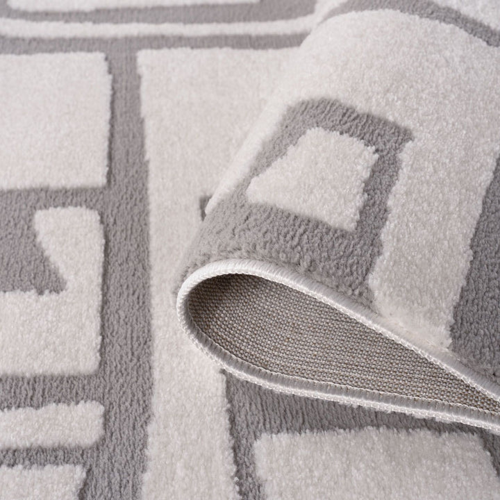 Gray textured rug with geometric pattern