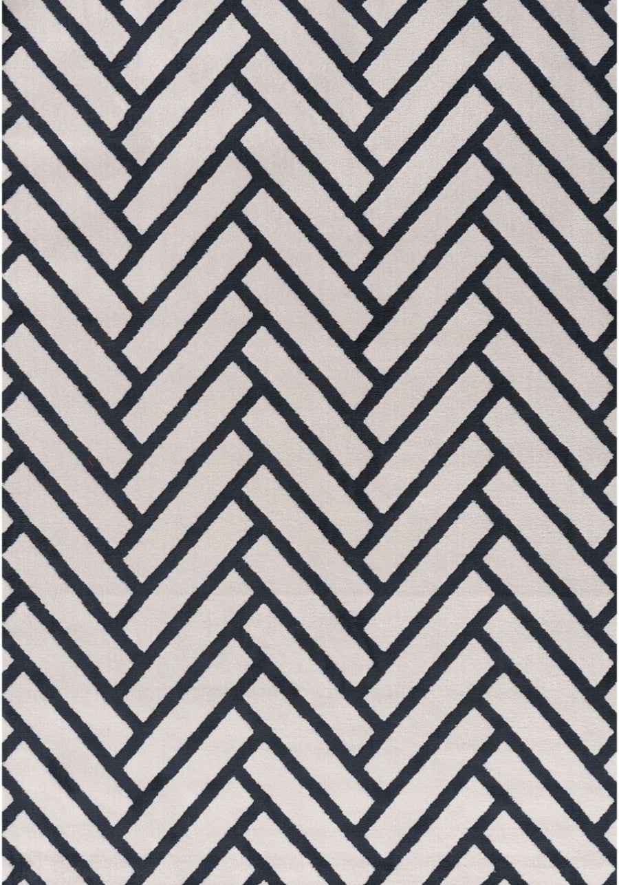 Rug with a black and white herringbone pattern