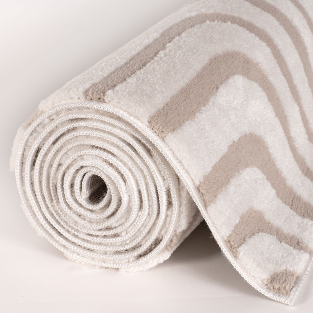 Rolled-up rug with chevron pattern on a light background