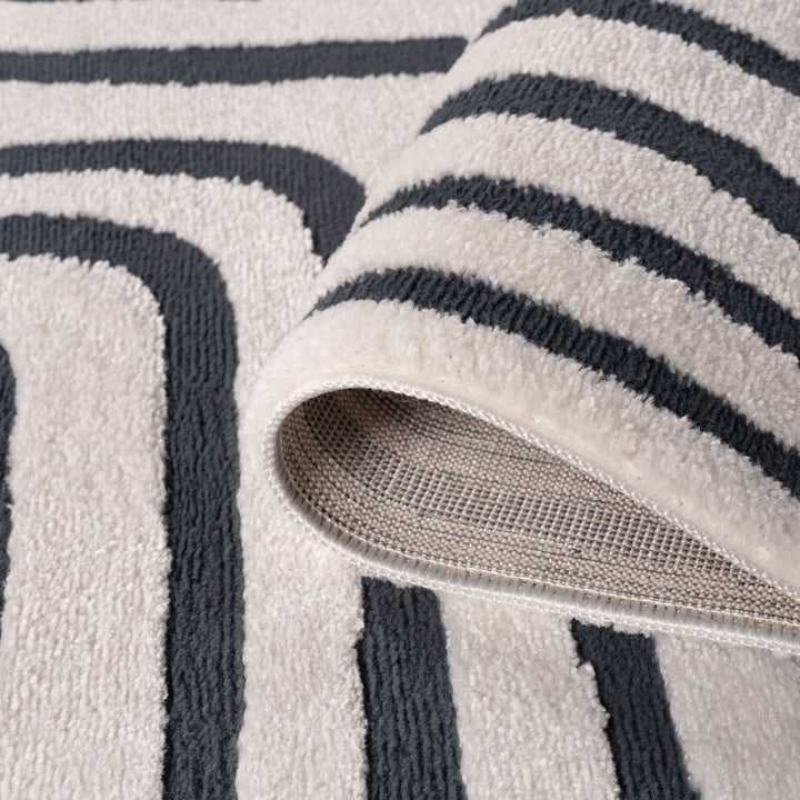 Close-up of a textured rug with black and gray stripes