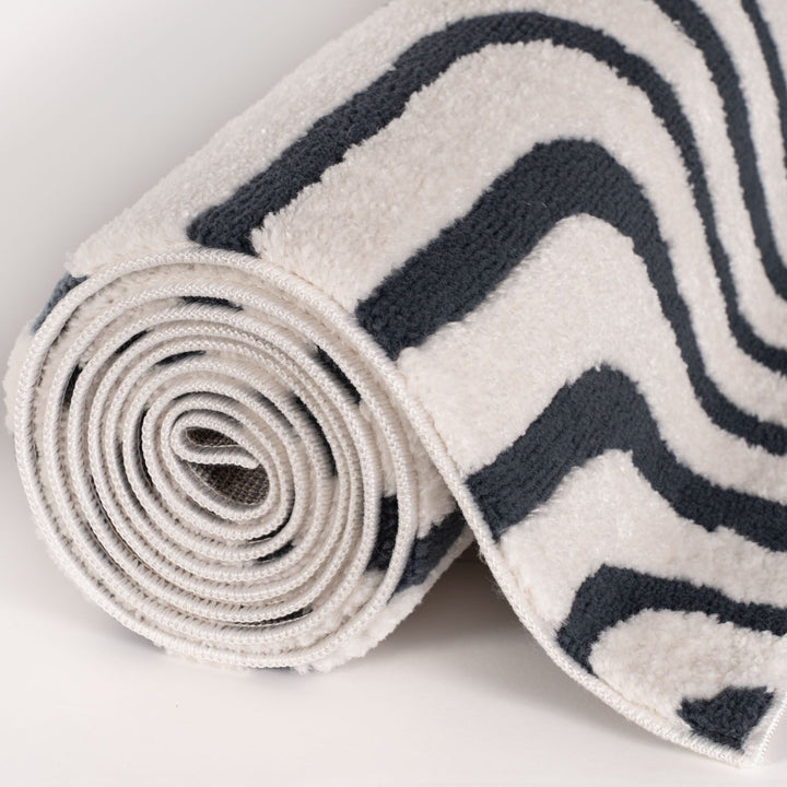Rolled-up rug with zebra pattern on a light gray background