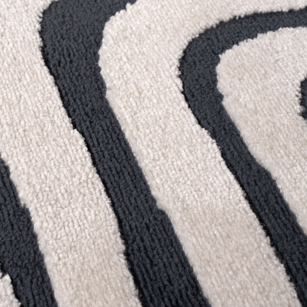 Close-up of a textured rug with black and white pattern