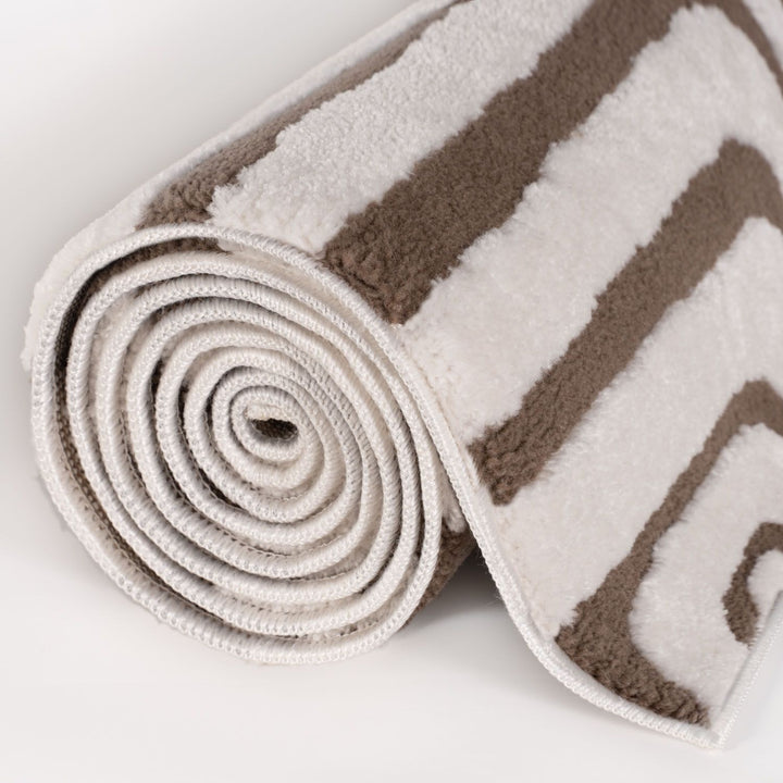 Rolled-up brown and white striped rug on a light gray background