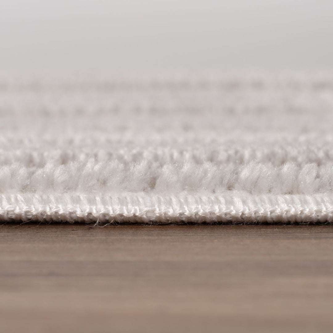 Close-up of a textured rug on a wooden floor
