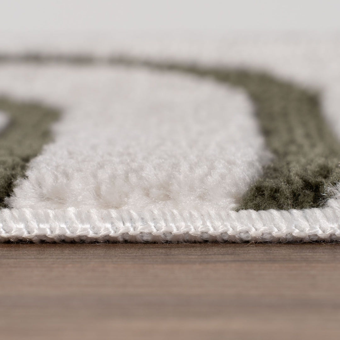 Close-up of a textured rug with geometric pattern on a wooden floor.
