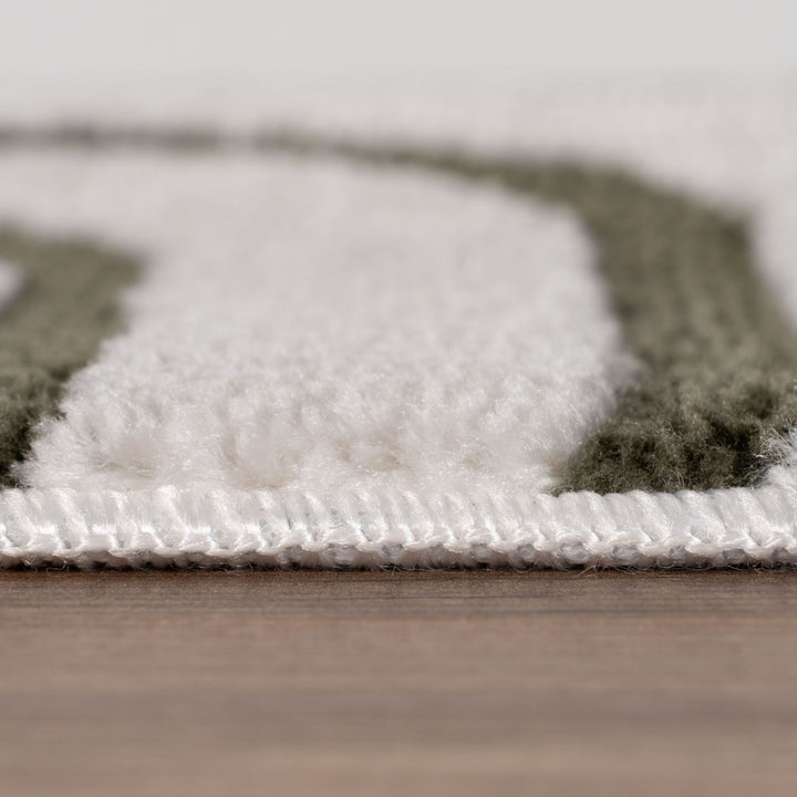 Close-up of a textured rug with geometric pattern on a wooden floor.