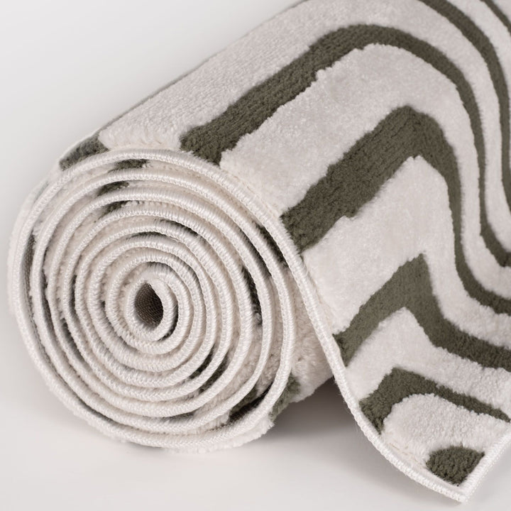 Rolled-up rug with zigzag pattern on a white background