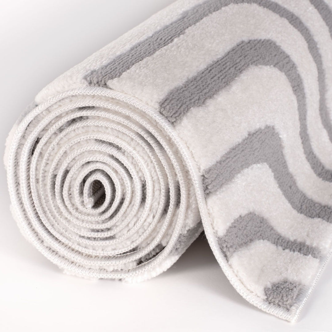Rolled-up towel with gray chevron pattern on a white background