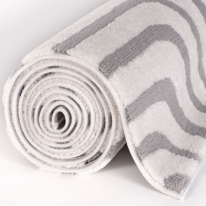 Rolled-up towel with gray chevron pattern on a white background