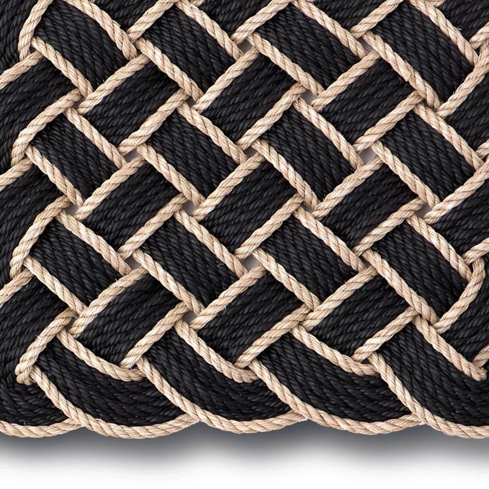 Close-up of black and beige braided rope on a white background