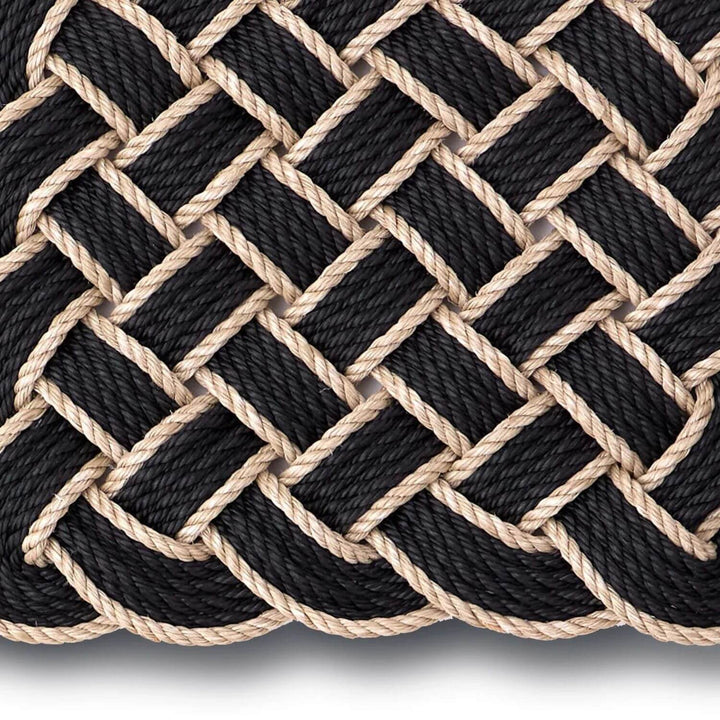 Close-up of black and beige braided rope on a white background