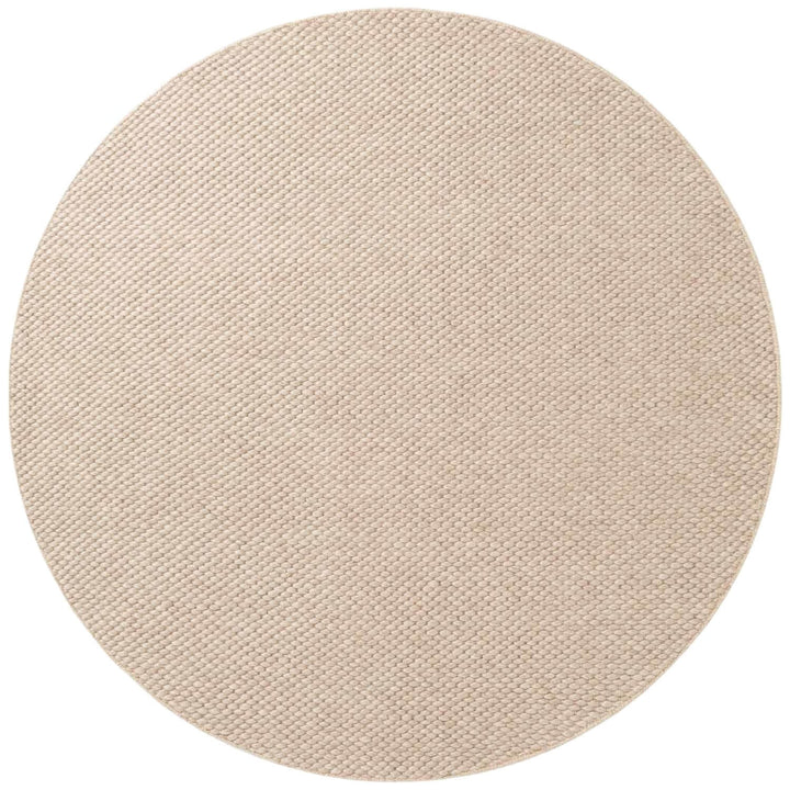 Round beige rug on a white background