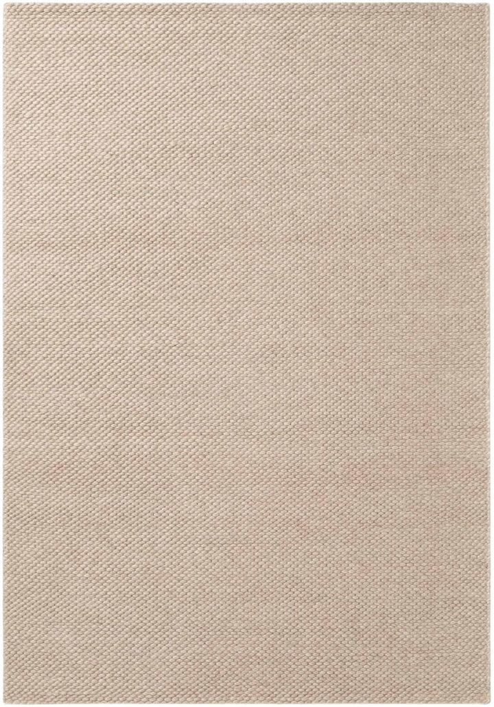Beige area rug with a subtle pattern