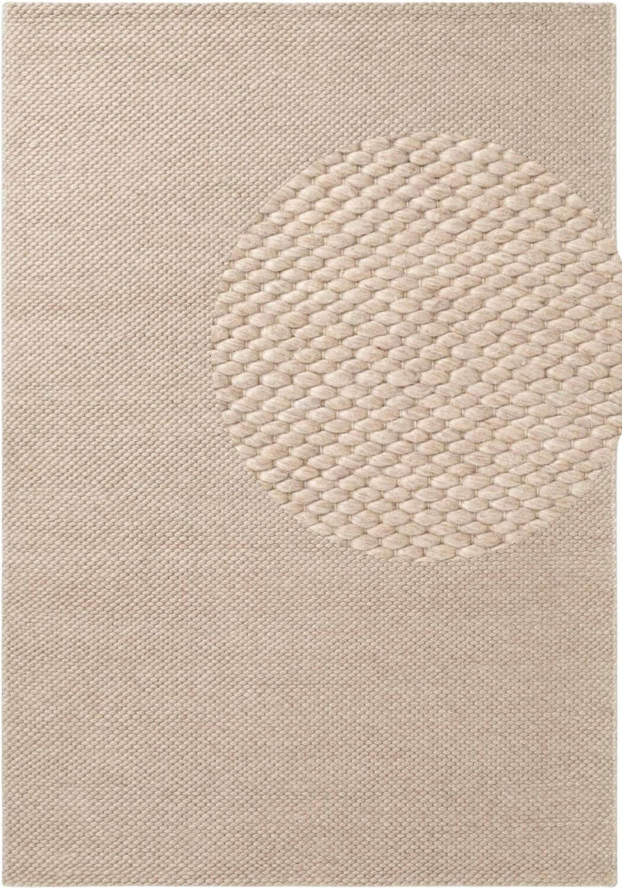 Beige textured rug with a circular pattern