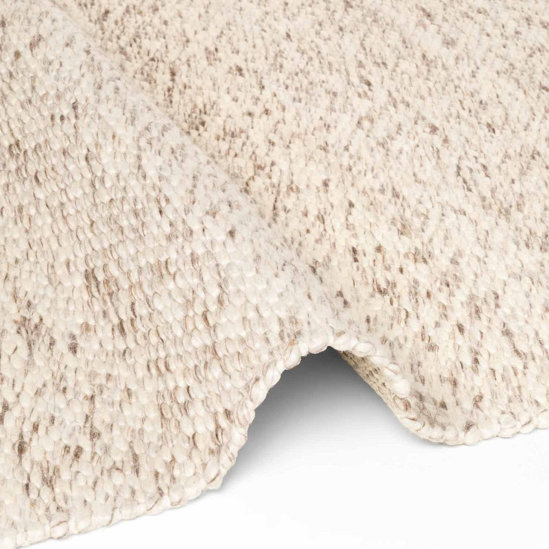 Close-up of a textured beige carpet corner