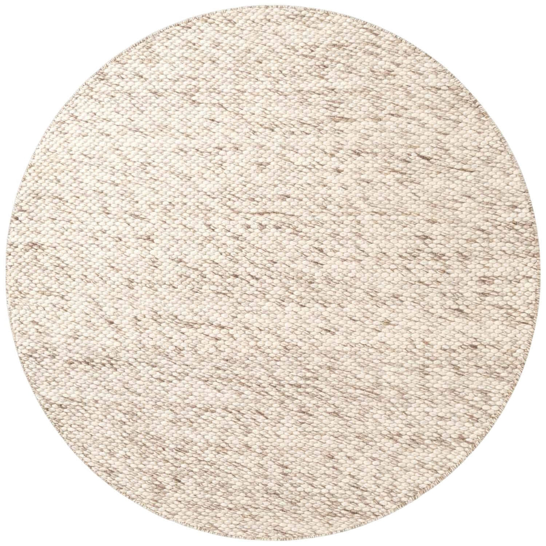 Round beige rug on a white background