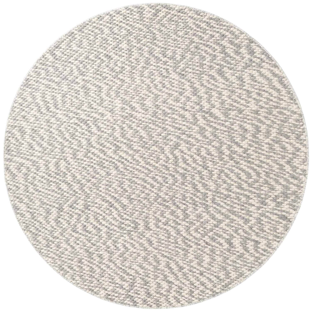 Round gray rug with a textured pattern on a white background