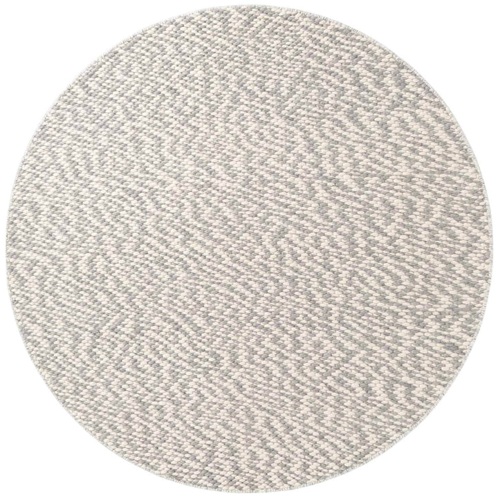 Round gray rug with a textured pattern on a white background