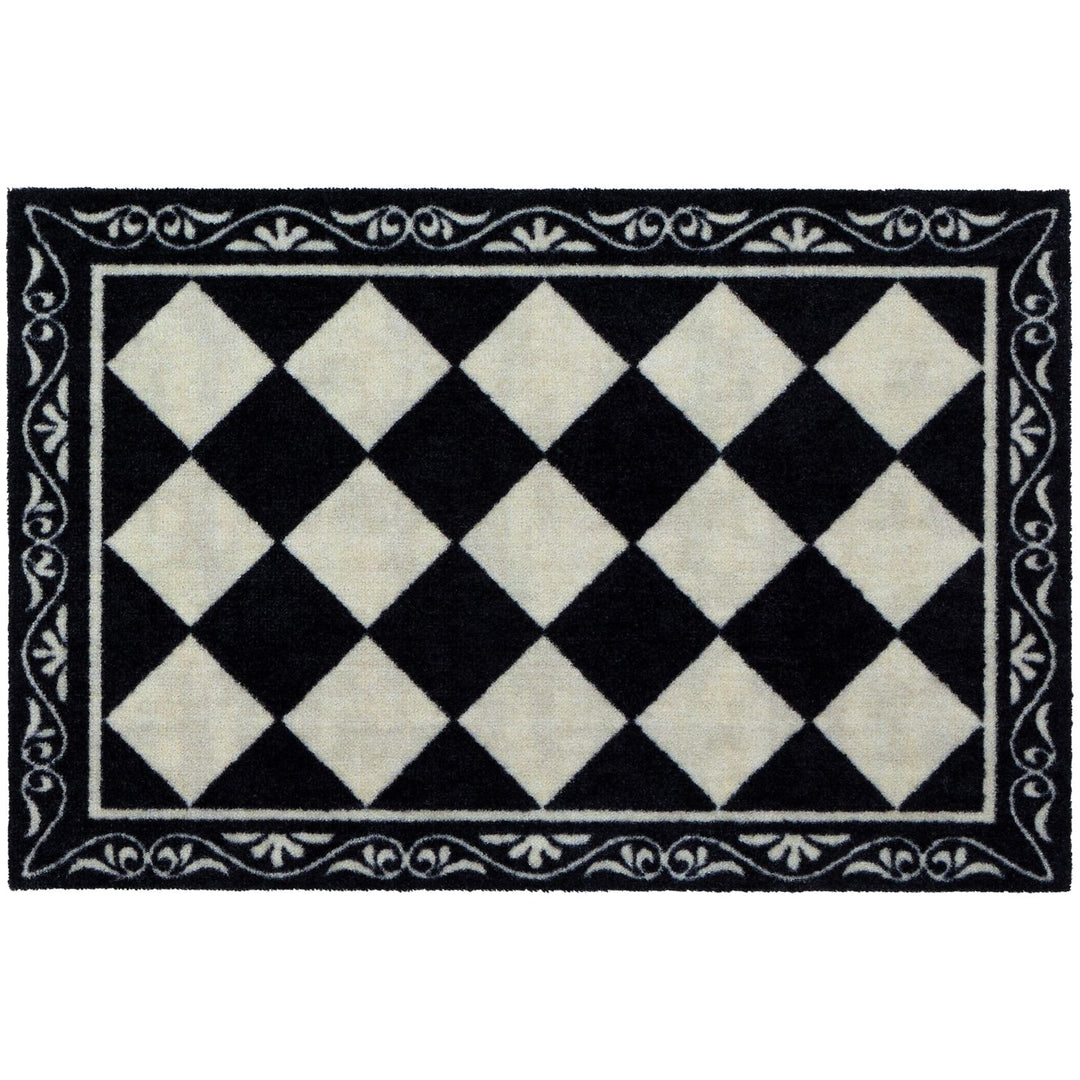Black and white checkered rug with decorative border on a white background