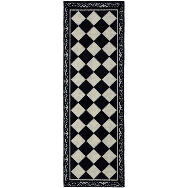 Black and white checkered rug with decorative border on a white background