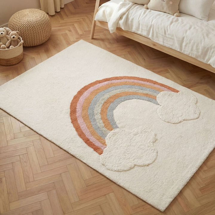 Beige rug with rainbow and cloud design on a wooden floor
