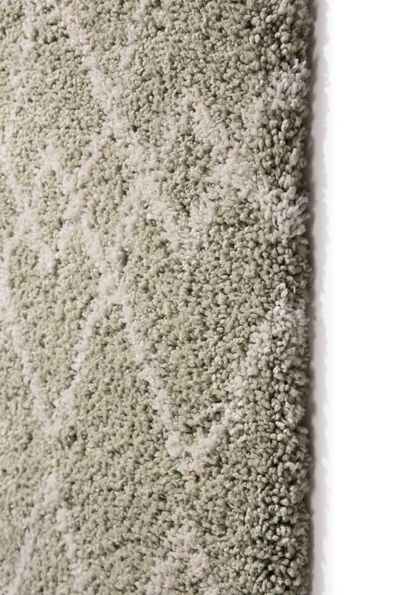 Close-up of Moroccan style rug in Eucalyptus Green and Ivory, showcasing intricate diamond pattern and plush texture.