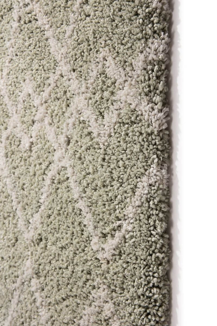 Close-up of Moroccan style rug in Eucalyptus Green and Ivory, showcasing intricate diamond pattern and plush texture.