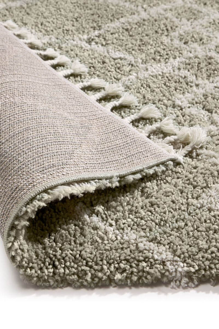 Detail of a Moroccan style rug in Eucalyptus Green and Ivory, showcasing plush texture and intricate design.