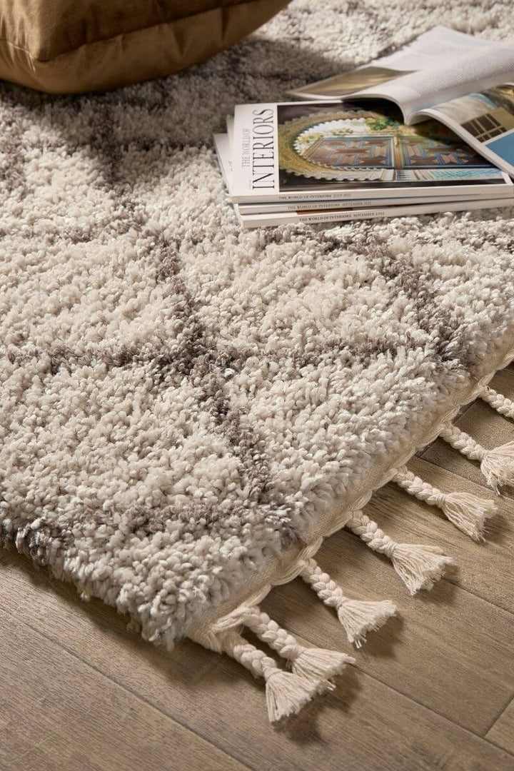 Moroccan style rug in soft cream and grey with tassels, perfect for adding charm to modern decor.