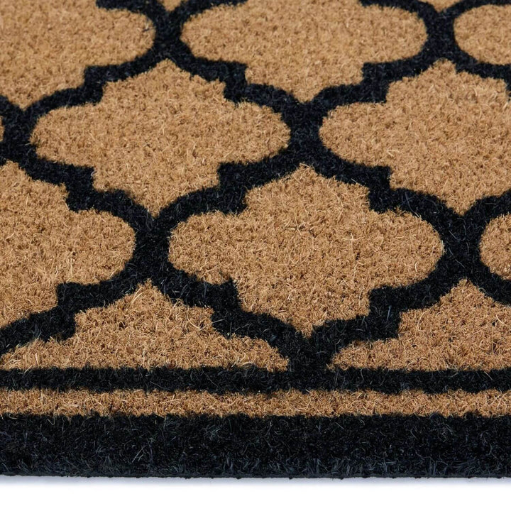 Doormat with black geometric pattern on a beige background