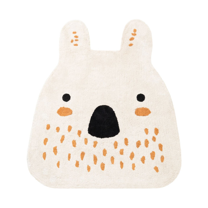 Knitted bear-shaped toy with orange spots on a white background