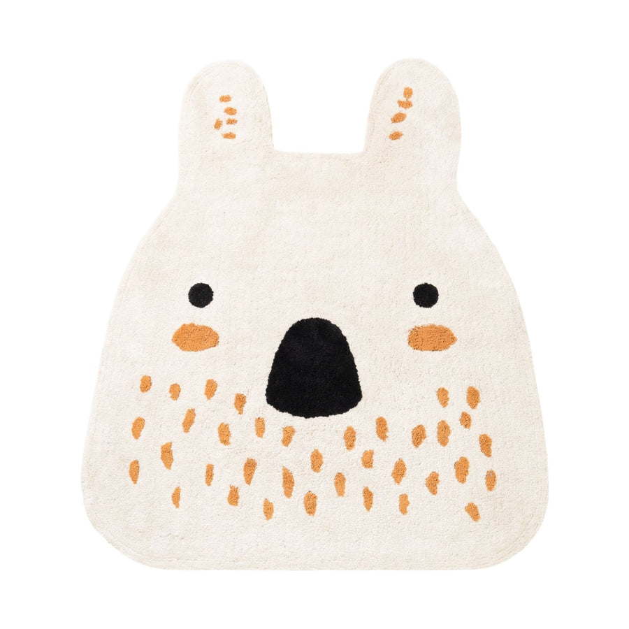 Knitted bear-shaped toy with orange spots on a white background