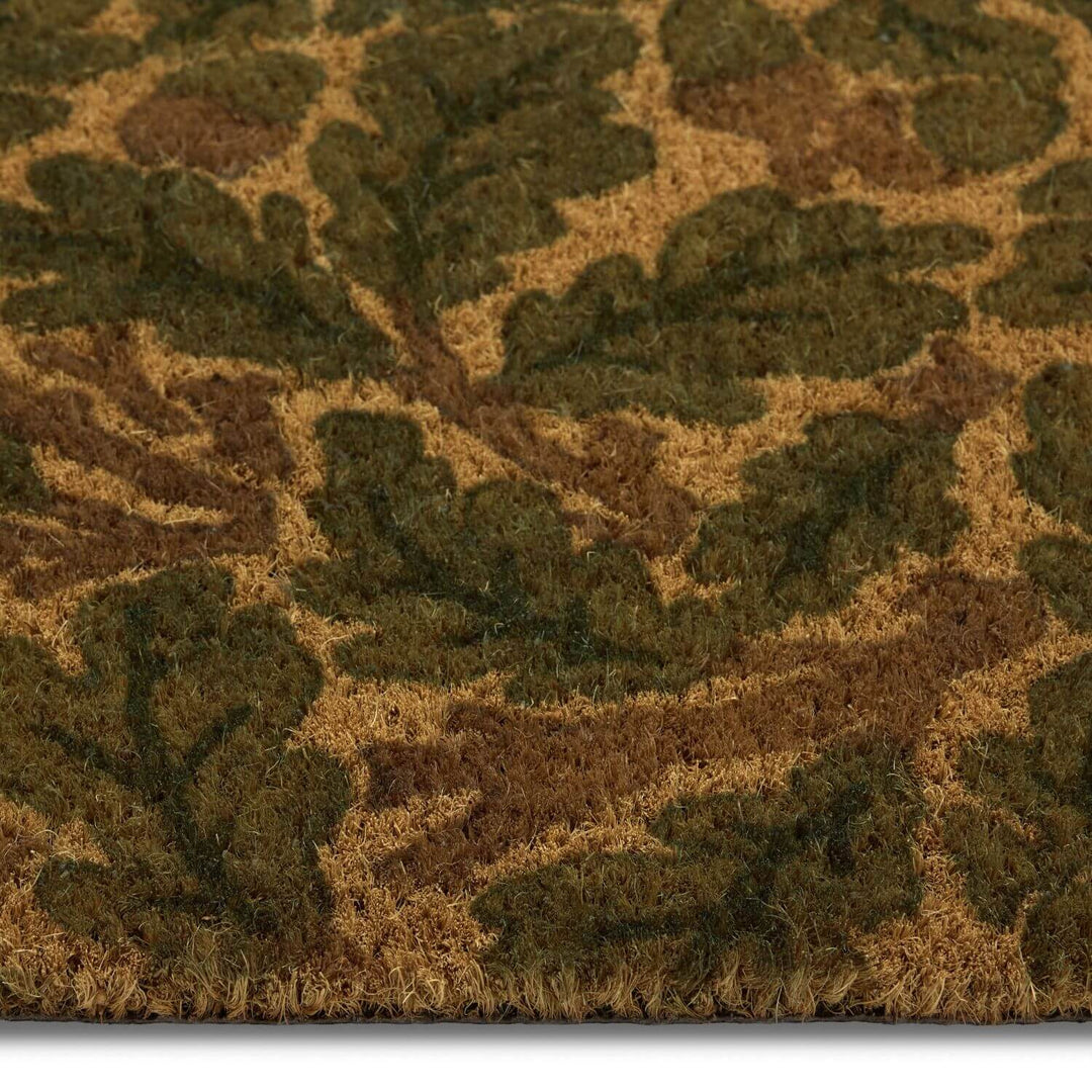 Close-up of a textured doormat with leaf pattern