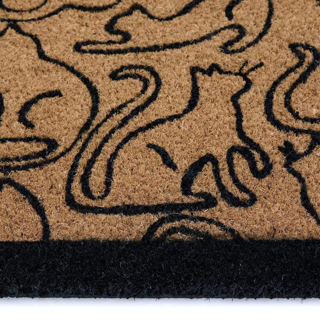 Doormat with black abstract design on a beige background