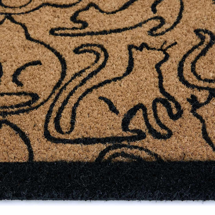 Doormat with black abstract design on a beige background
