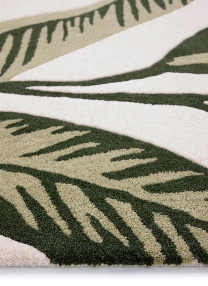 Paradise Leaf hand-tufted wool rug featuring cream and green leaf patterns, ideal for adding nature-inspired elegance to any room.